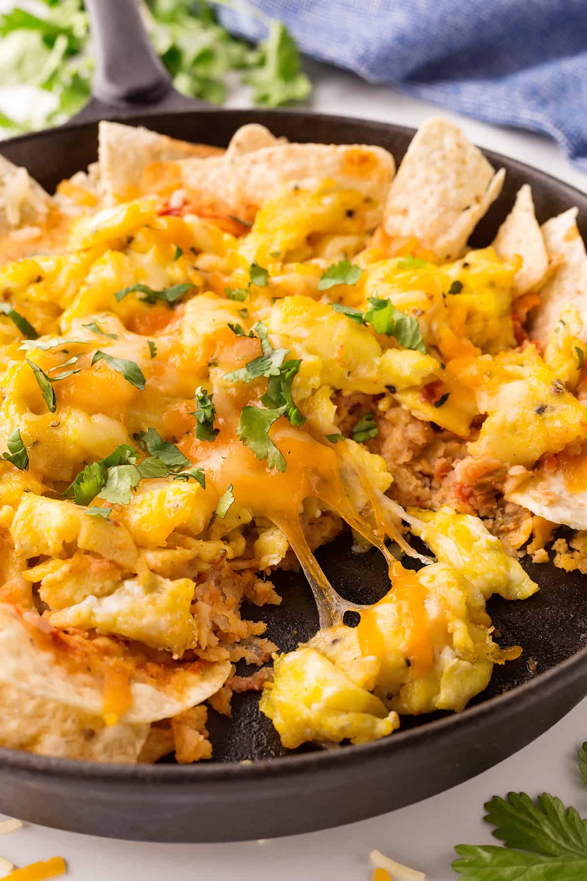 Showing the cheese pull in a skillet with the eggs. 